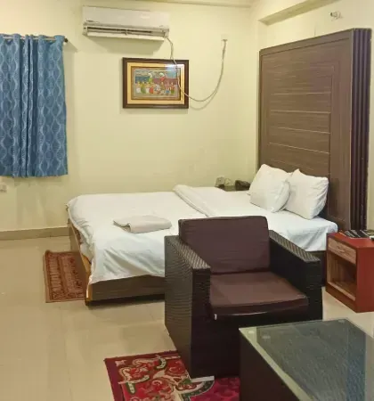 Twin-bed room with armchair and work space